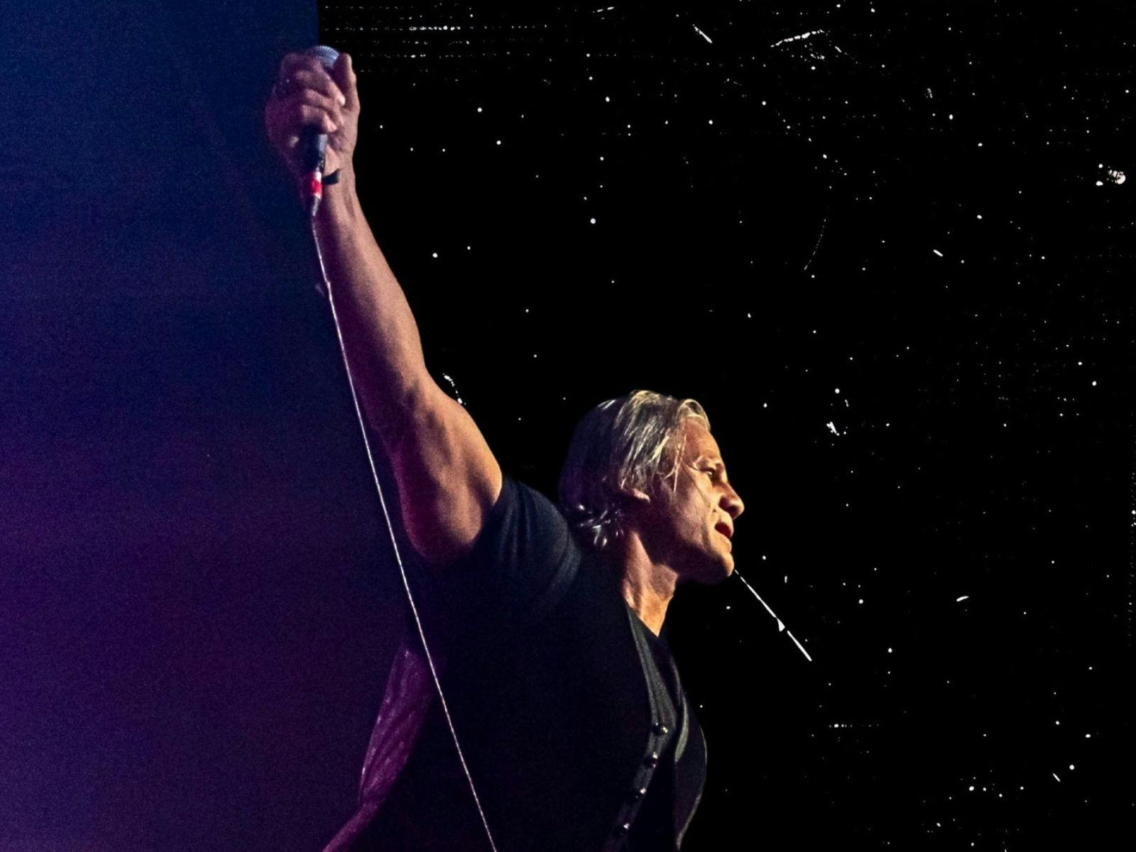 Dark image of Jon with right arm up Dark image of Jon with right arm up