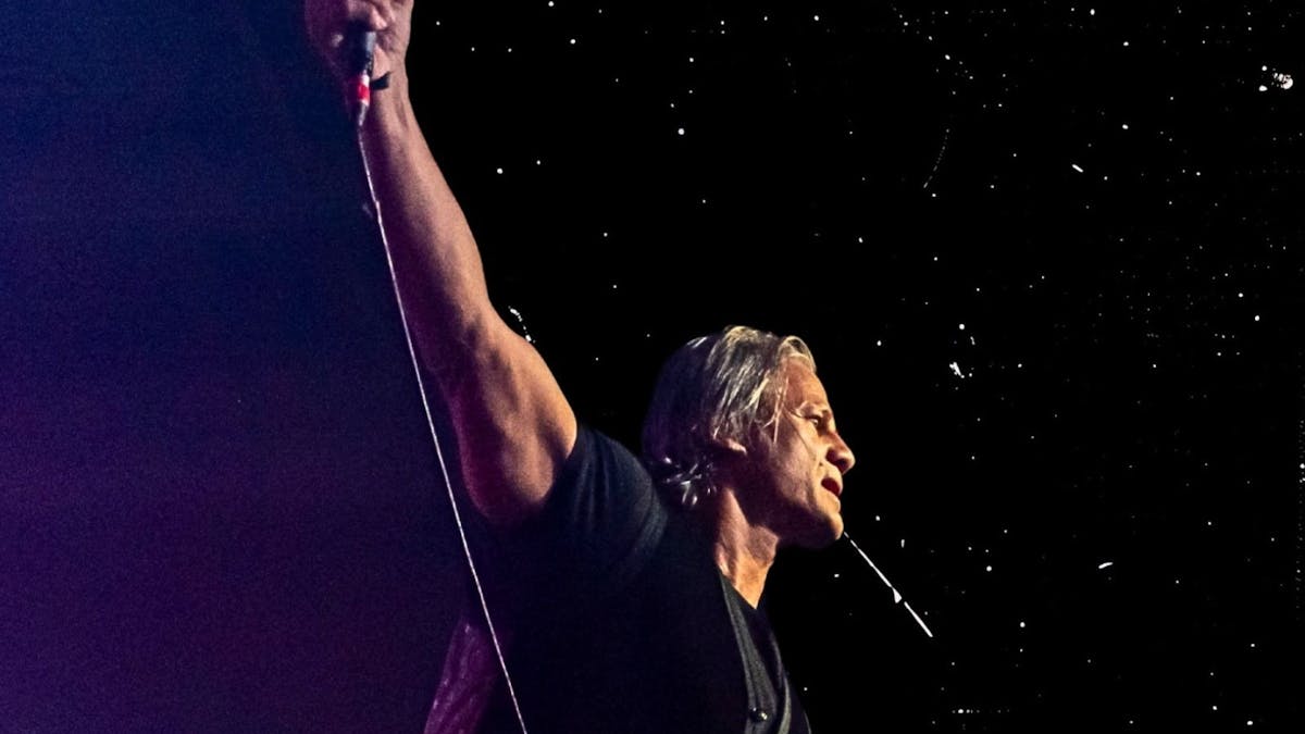 Dark image of Jon with right arm up