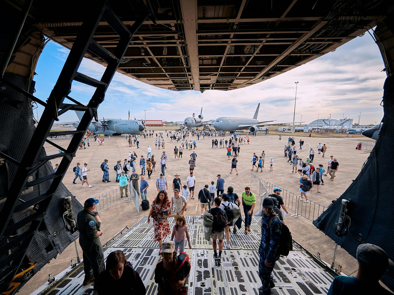 Attendees Walking Inside a Military Plane
