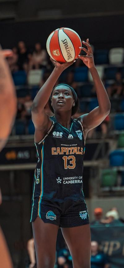 Basketball player in motion of shooting a basketball.