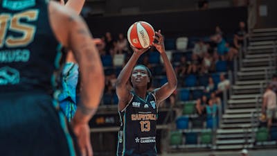 Basketball player in motion of shooting a basketball.