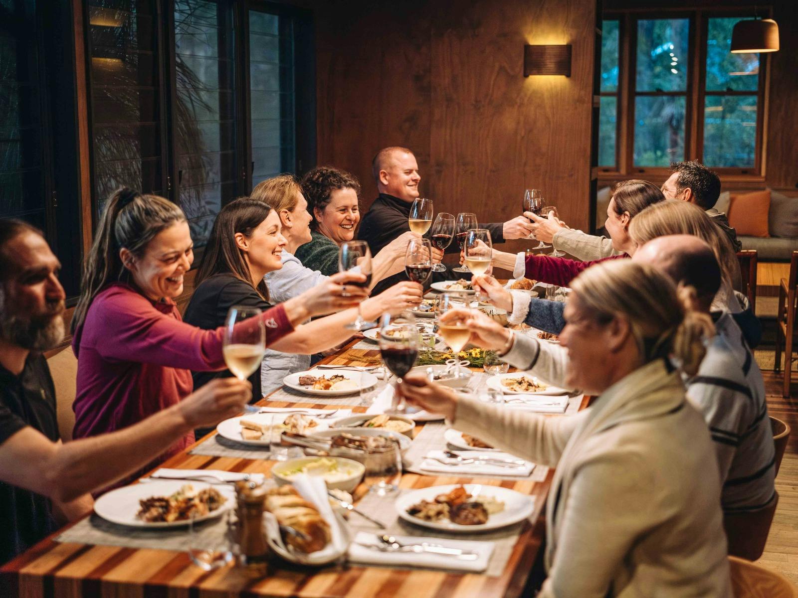 Hiking group eating dinner at accommodation