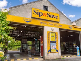 Exterior of drive through SipnSave store.