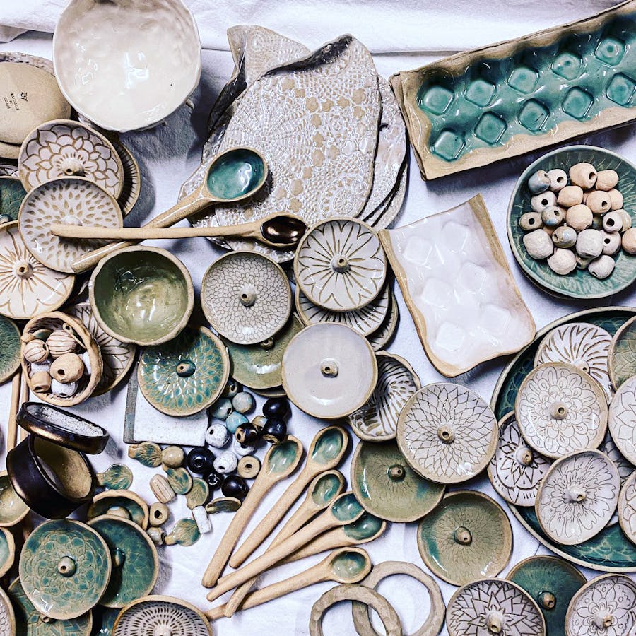 a photo showing a variety of handmade ceramic items, including incense burners, platters and spoons