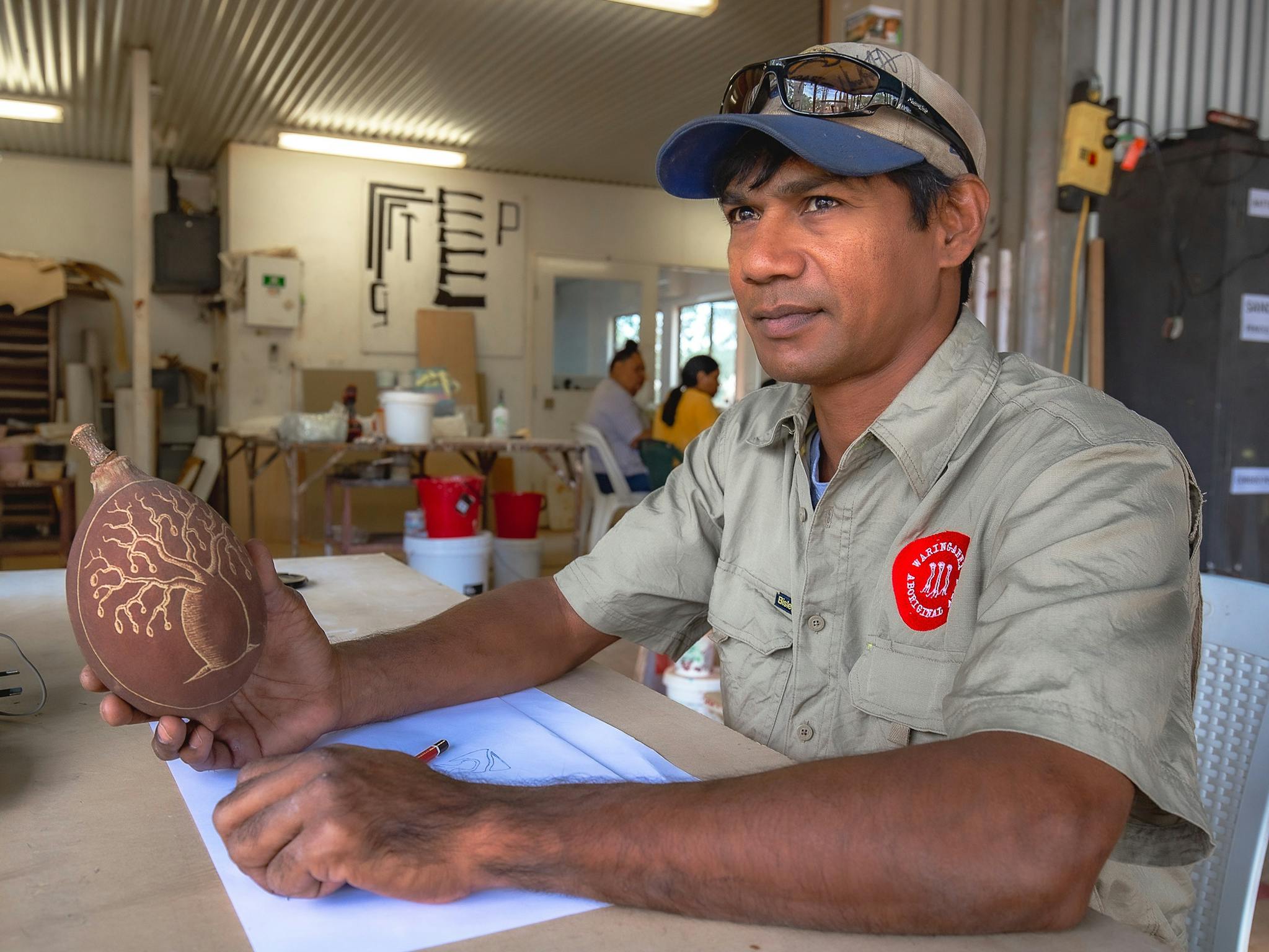 Indigenous artist Nathan Thomas with engraved boab nut