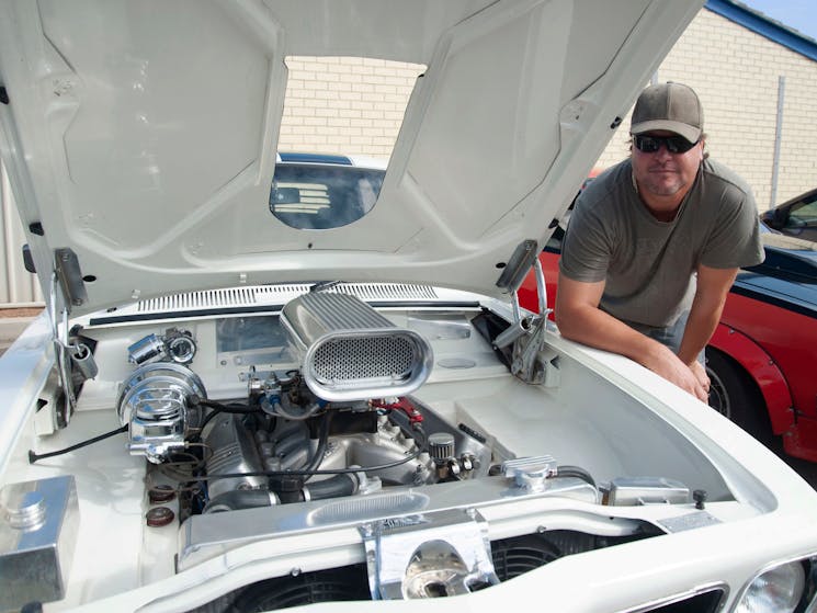 Motoring Enthusiast showing off car engine