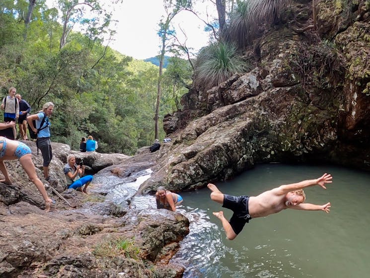 participant leaping into the water at Hells Hole pools in Mount Jerusalem National Park