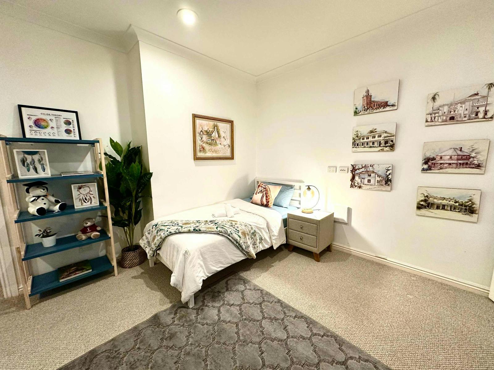 Downstairs Room 3 featuring a double bed, shelving, and cosy styling.
