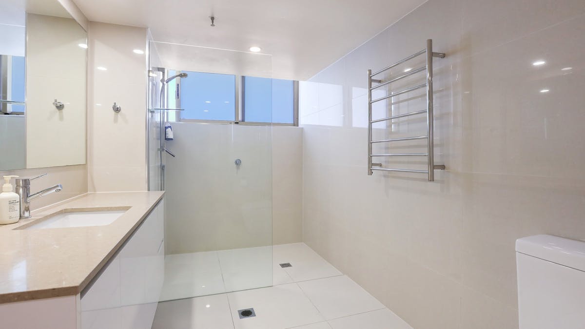 Shared bathroom with vanity, Shower, washing machine and dryer