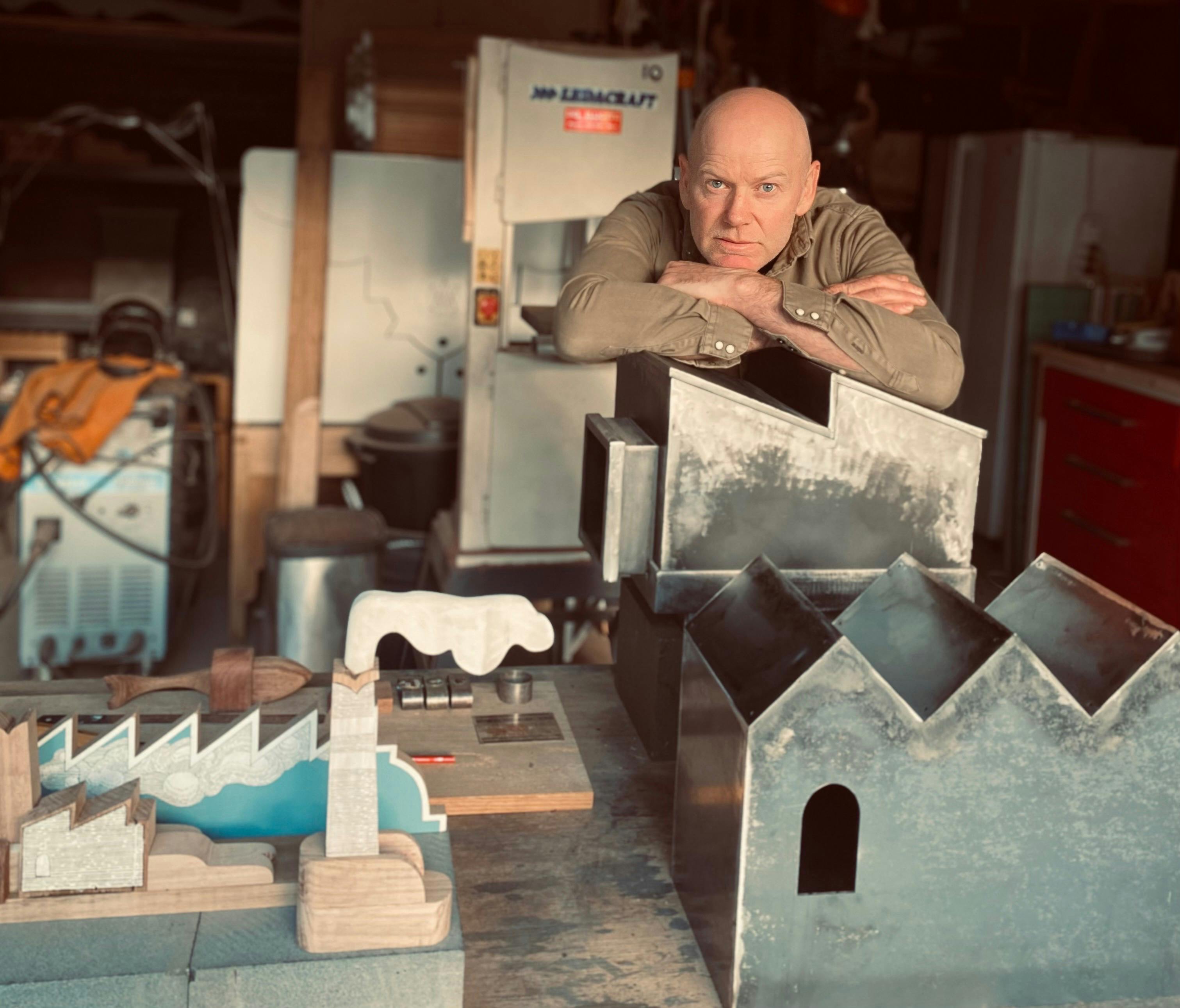 Cameron Ross in his studio with his sculptures
