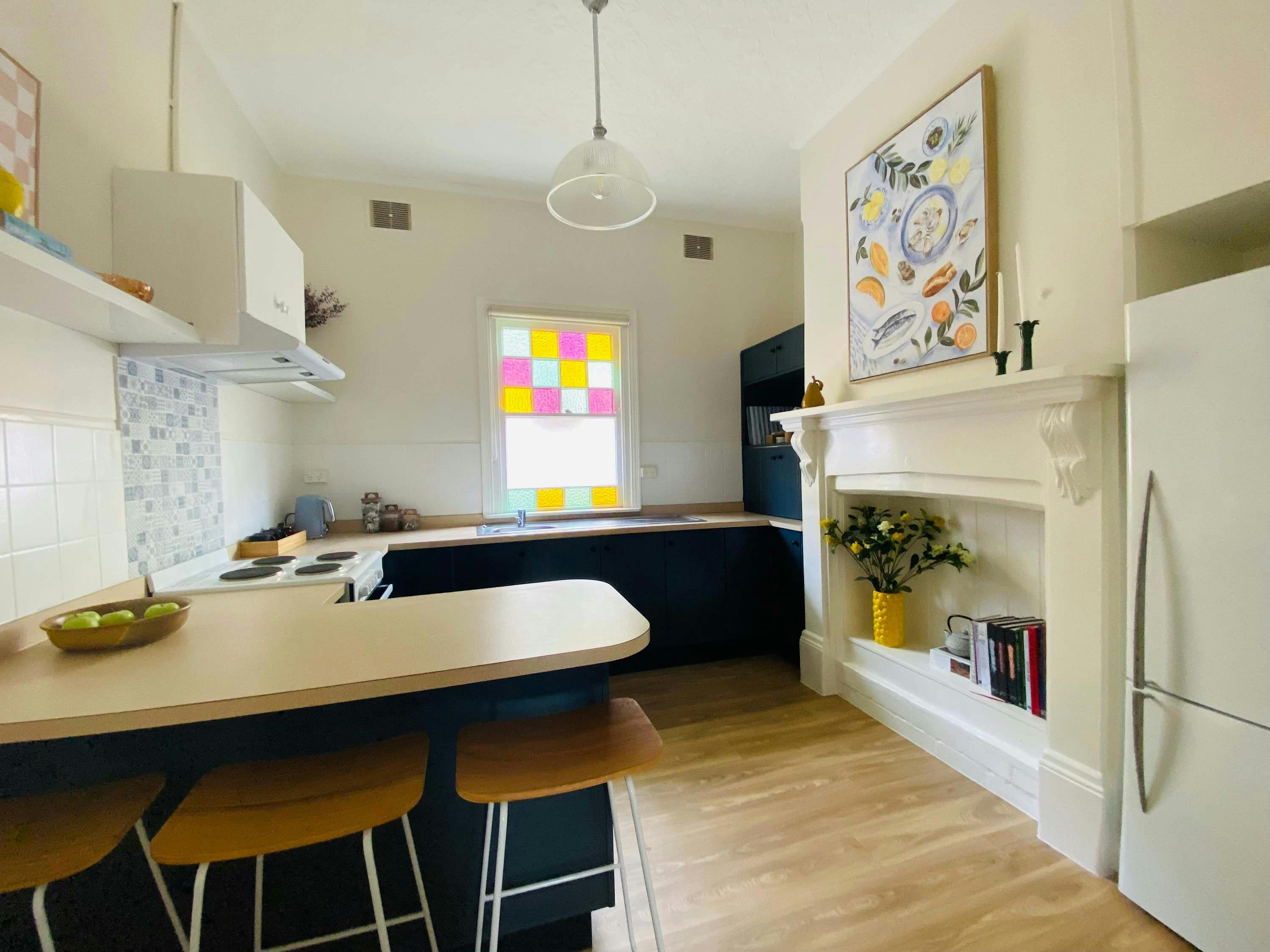 Kitchen with stove and oven, bench space and fridge at 161 Rankin st