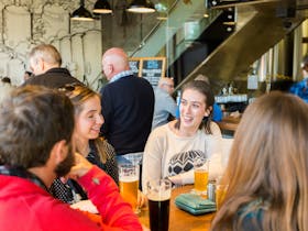 People having beers in the downstairs bar