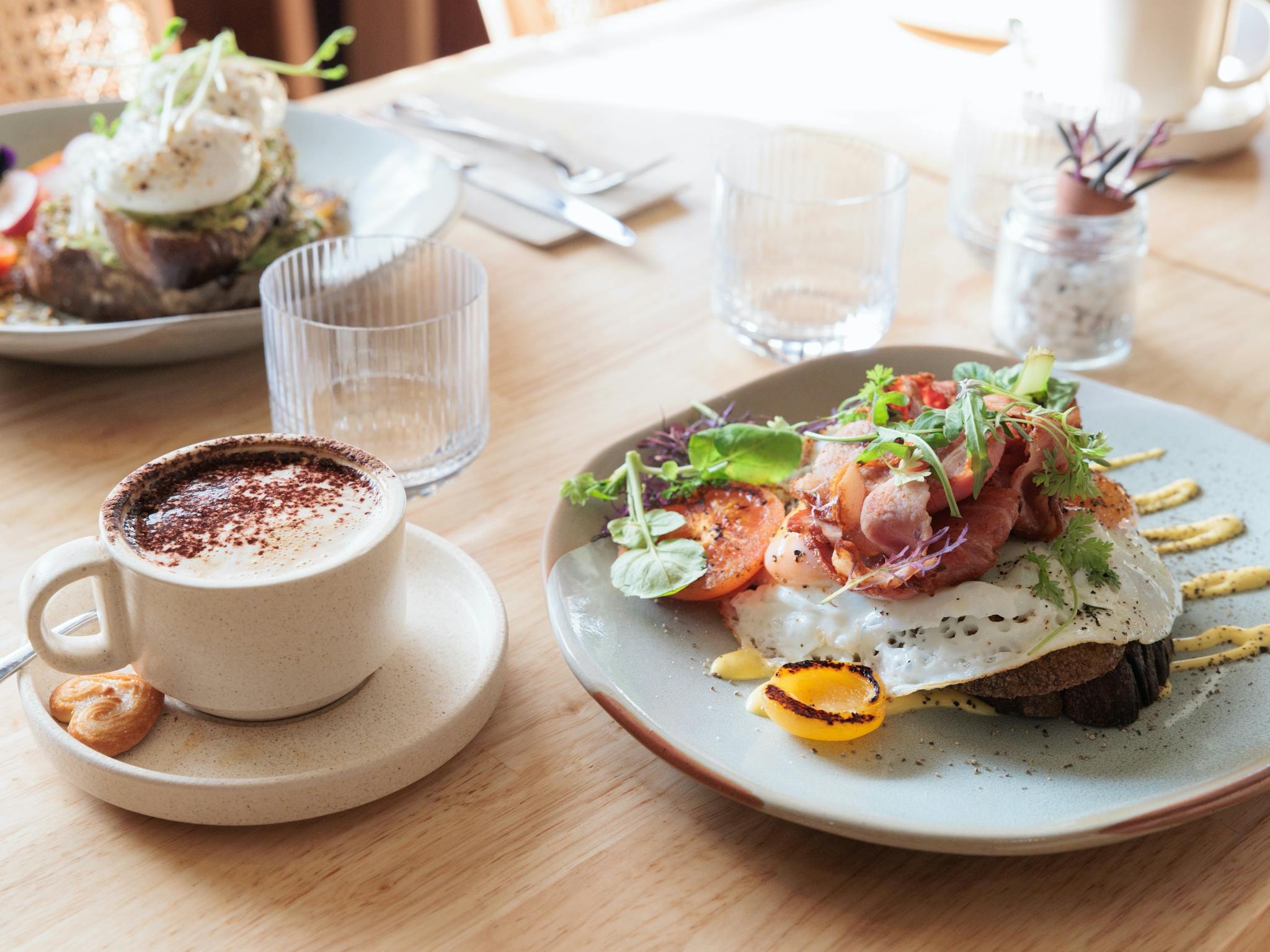 Image of tabletop with coffee and menu item Bacon and Eggs