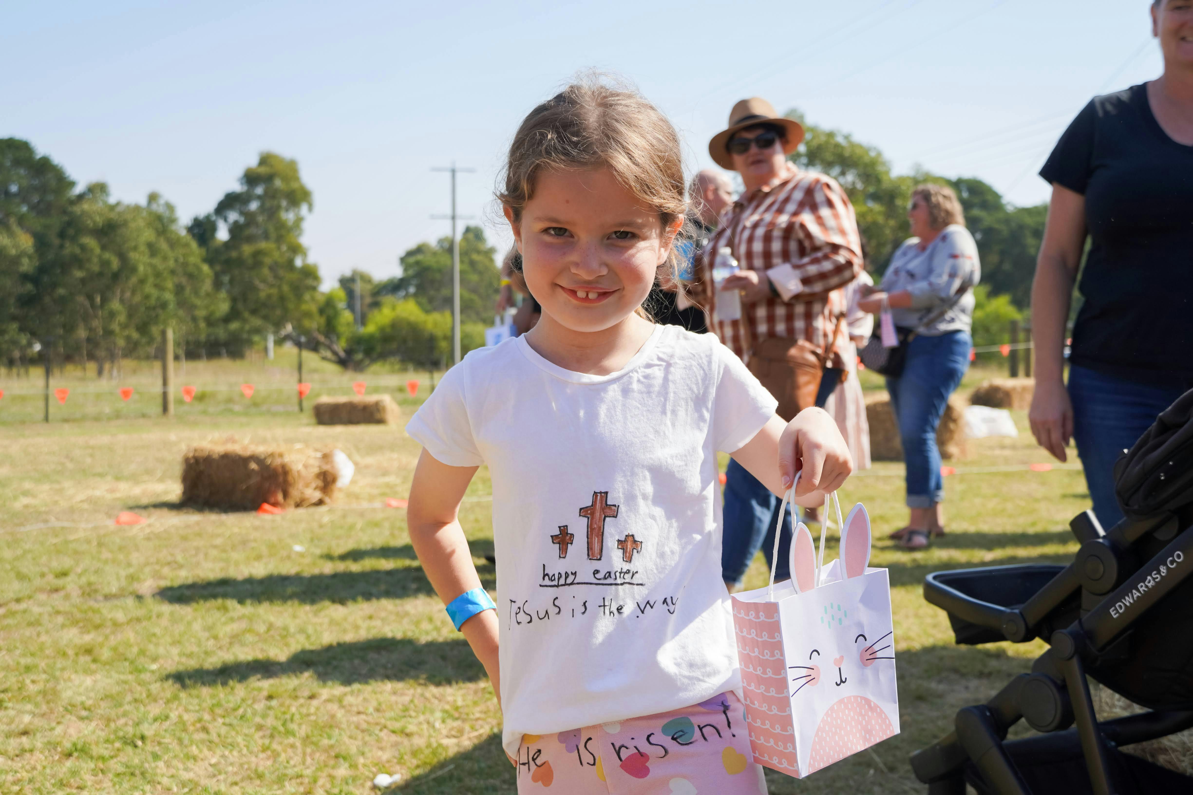 A child smiling with an Easter bag