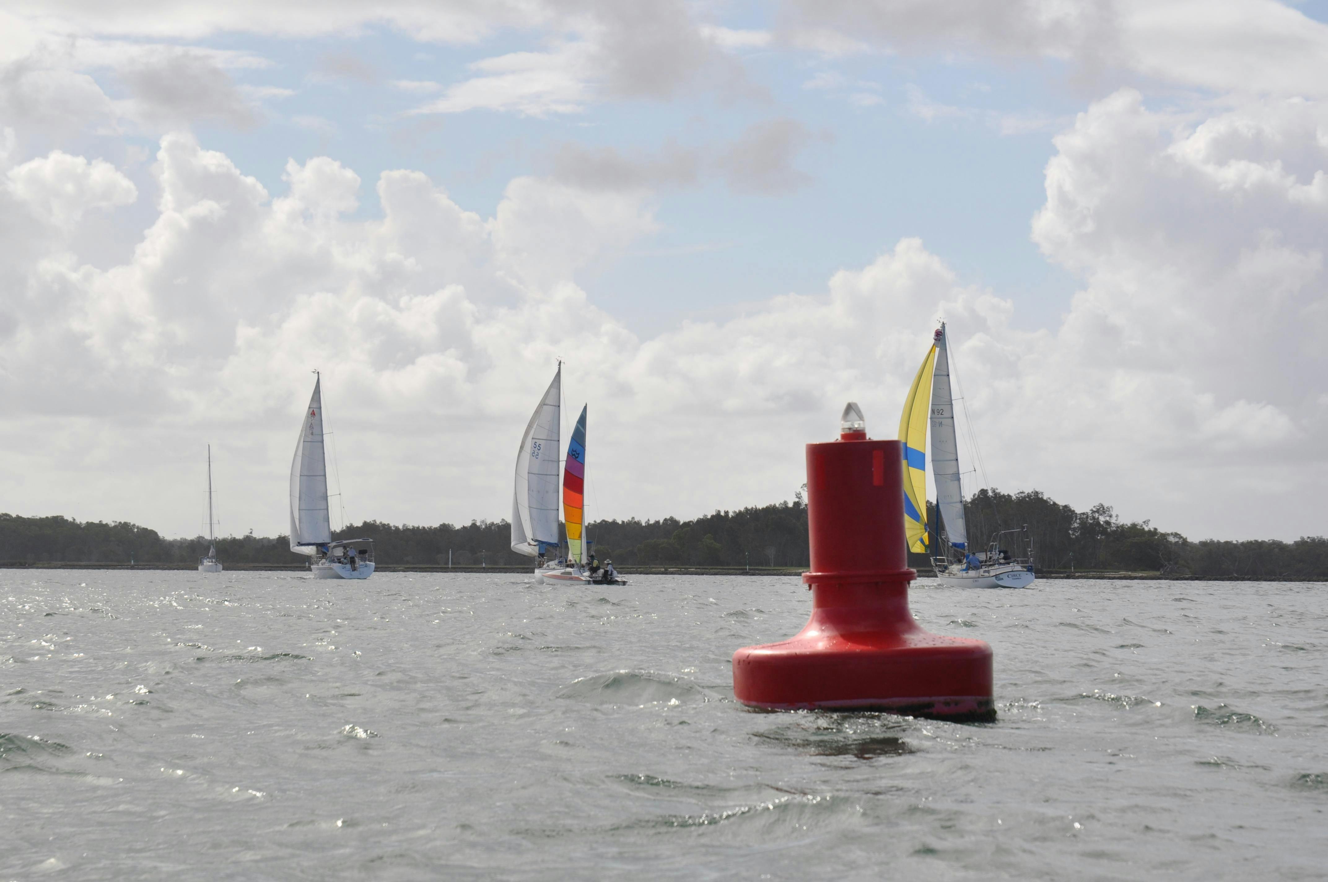 Sailboats rounding a bouy