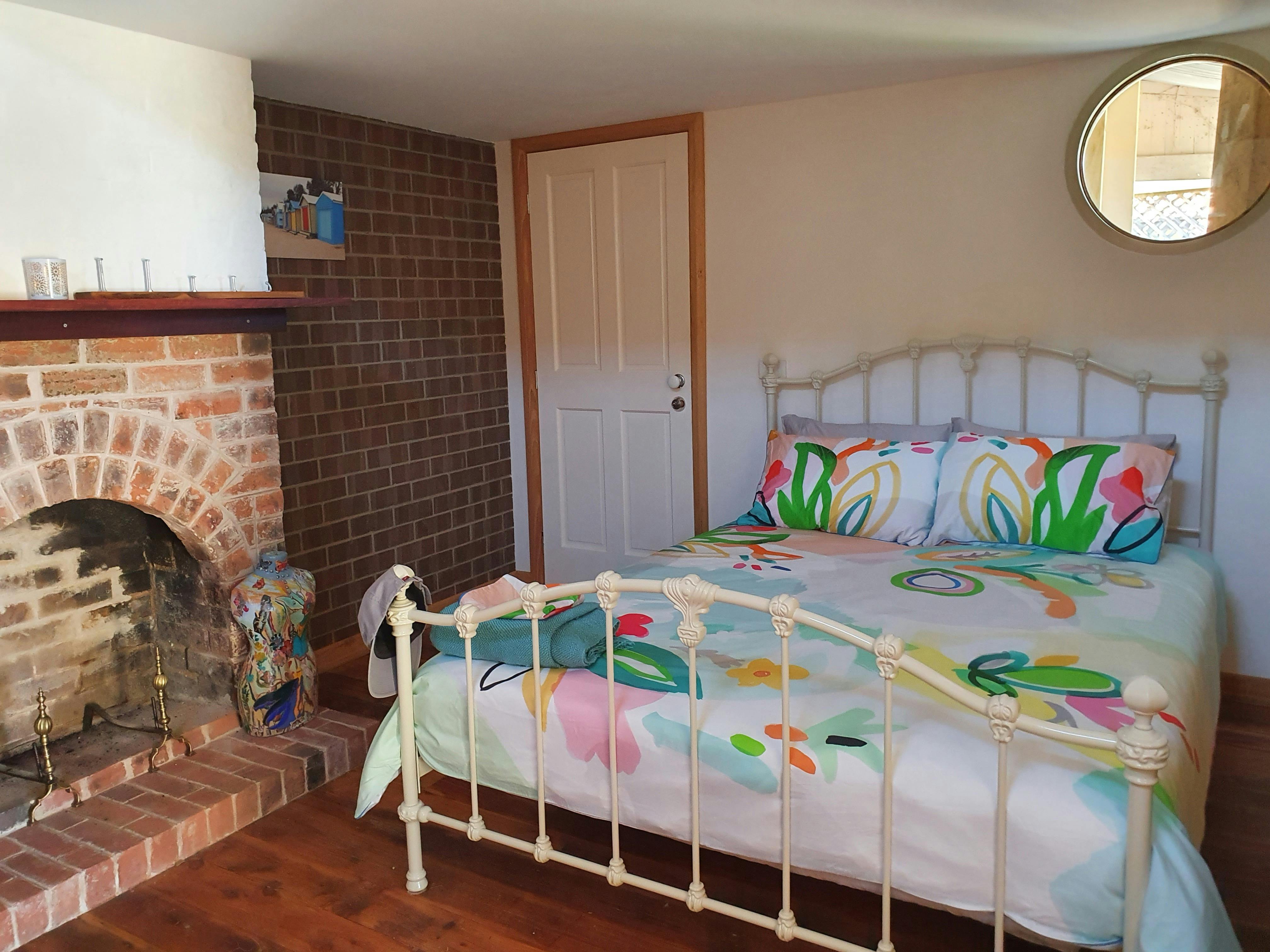 Bedroom with the original fireplace. Cosy in winter and cool in summer.