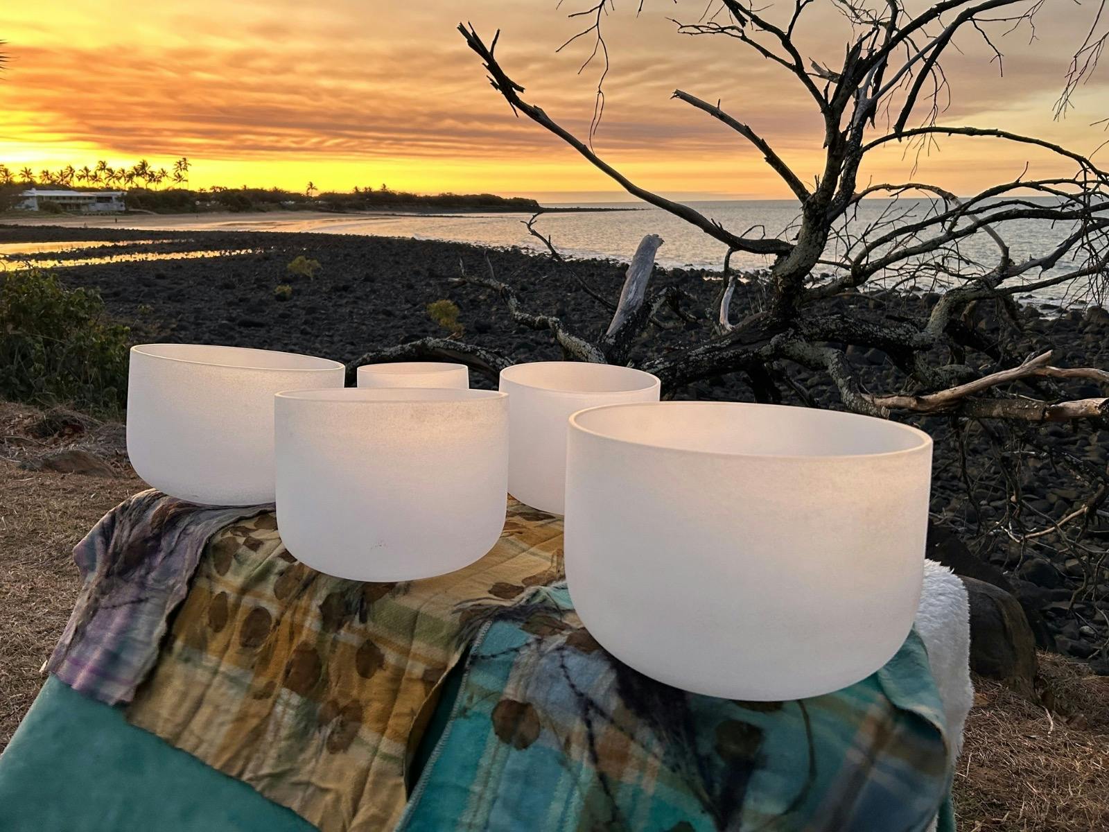 Singing Bowls on a beautiful woolen eco dyed cover with the sunset near the Ocean