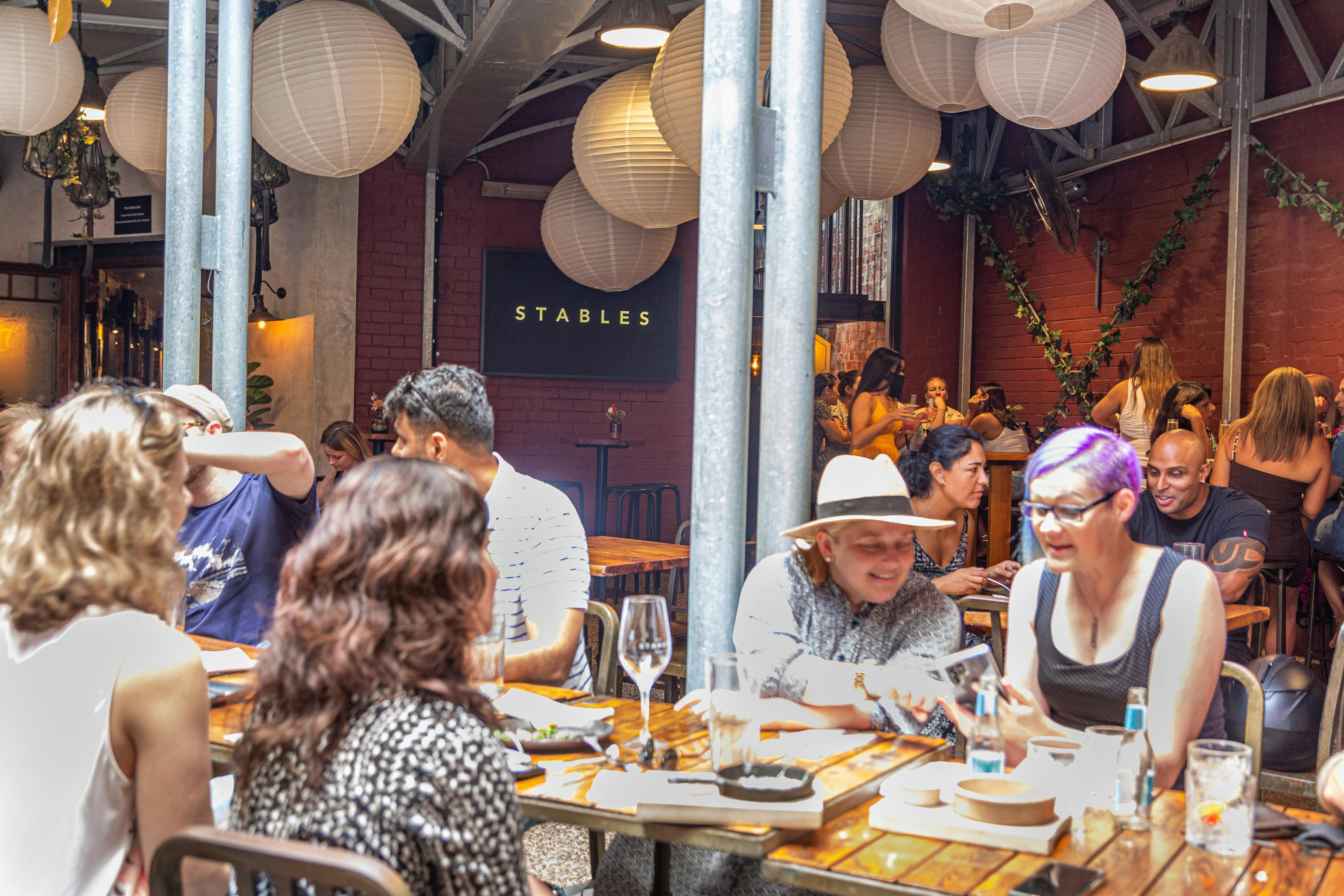 Group of people having a long table lunch