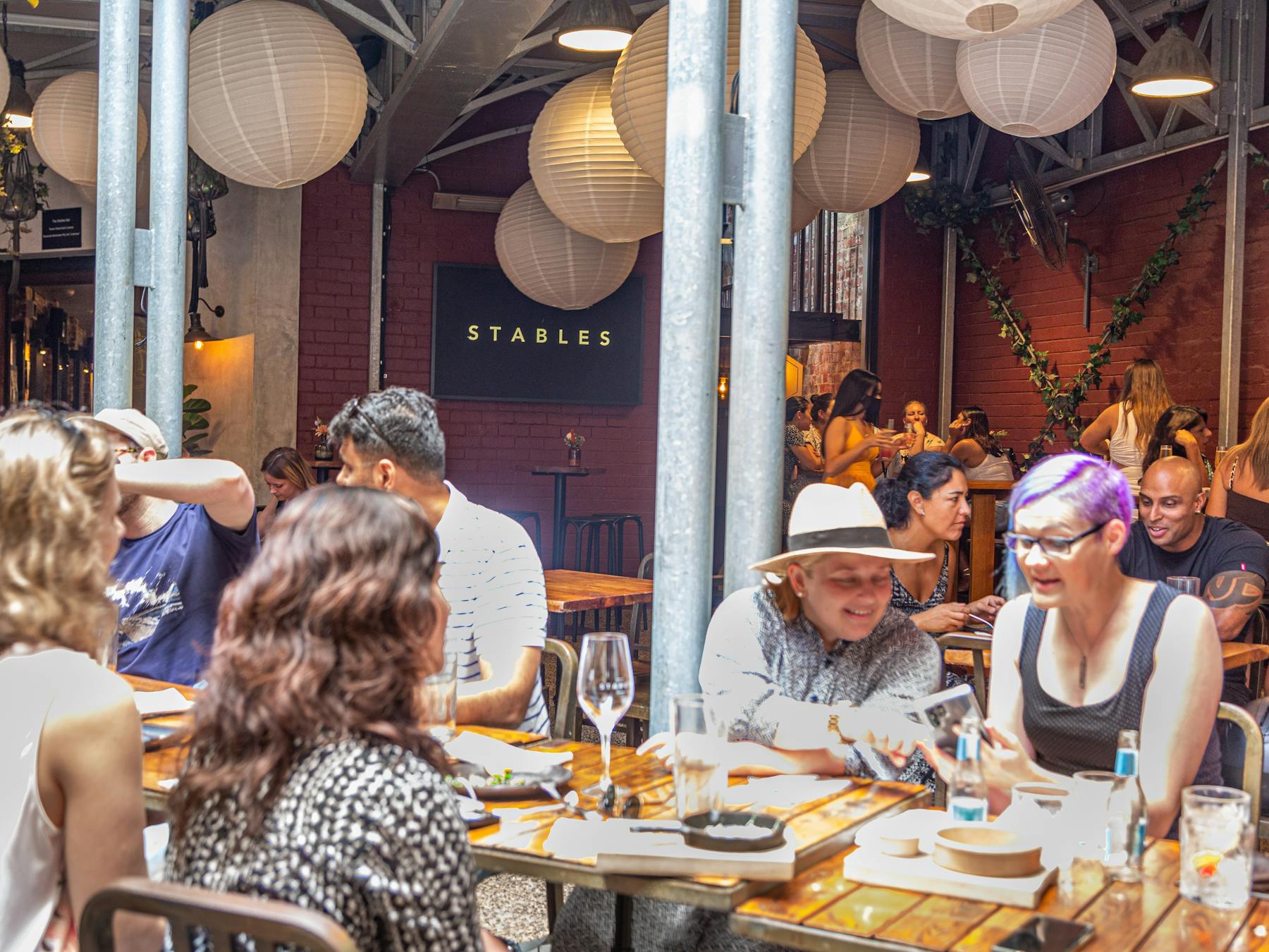 Group of people having a long table lunch