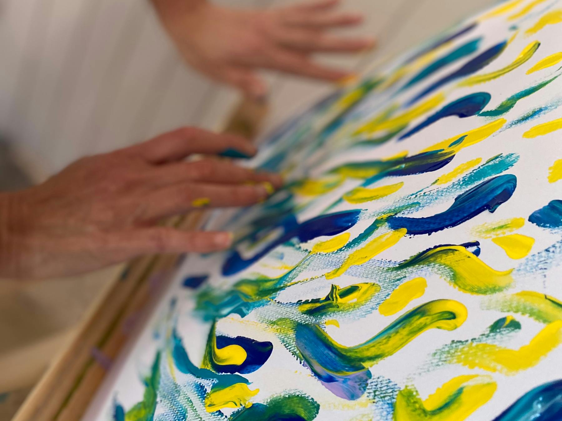 Art on an easel - painted with blue and yellow - with fingers