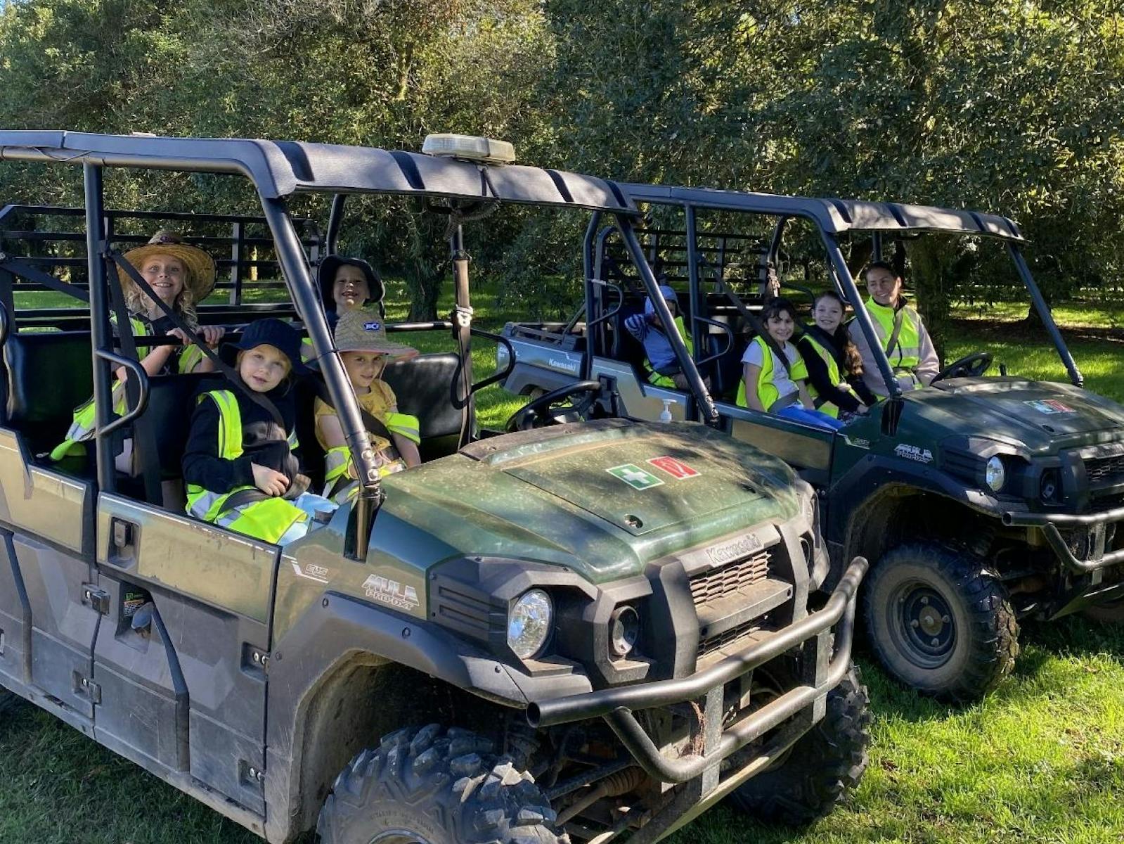 Kids on two ATV vehicles on the farm