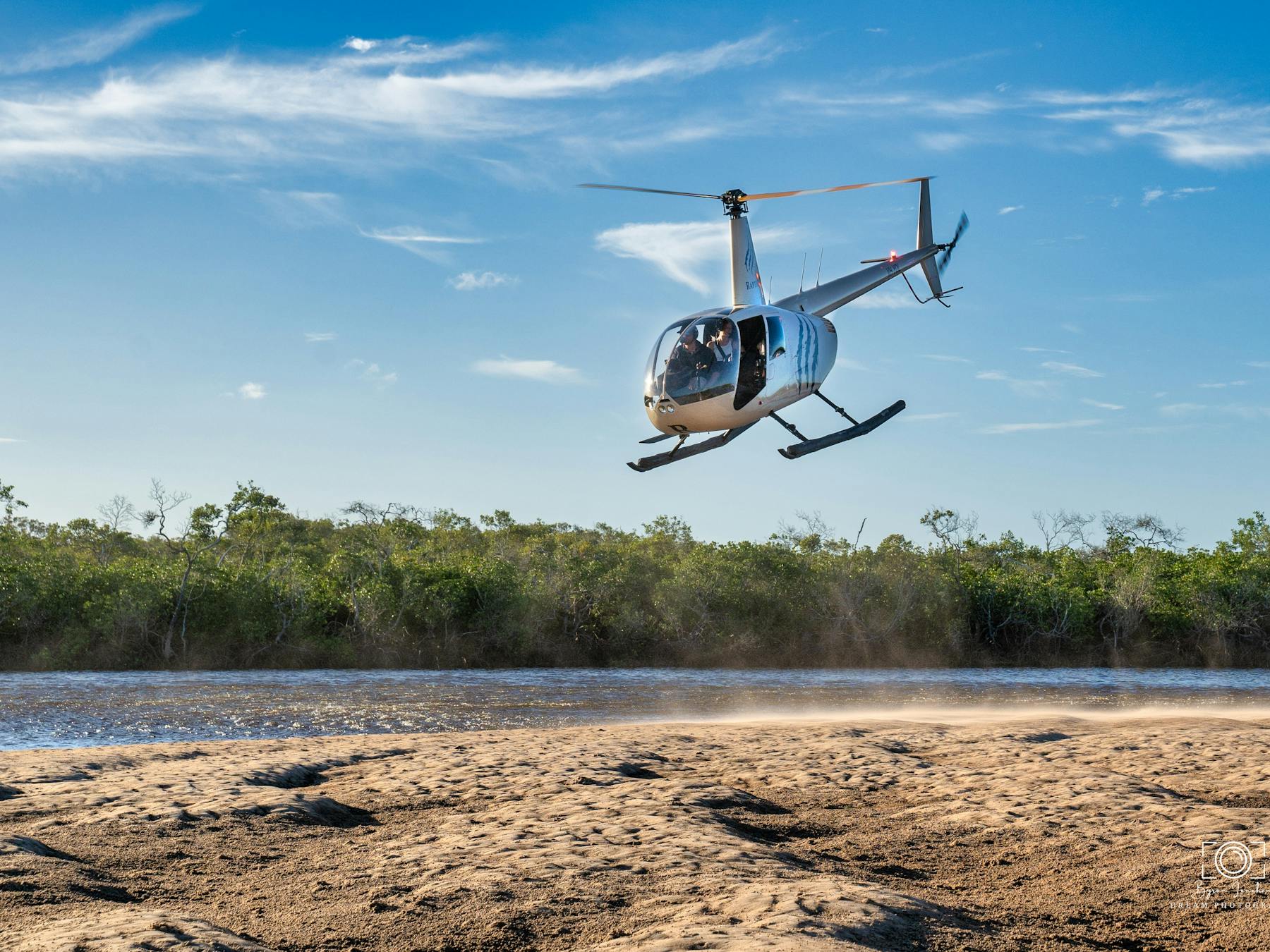 the helicopter is coming to land from Mangrove to Beach and stunning colours of greens and blues
