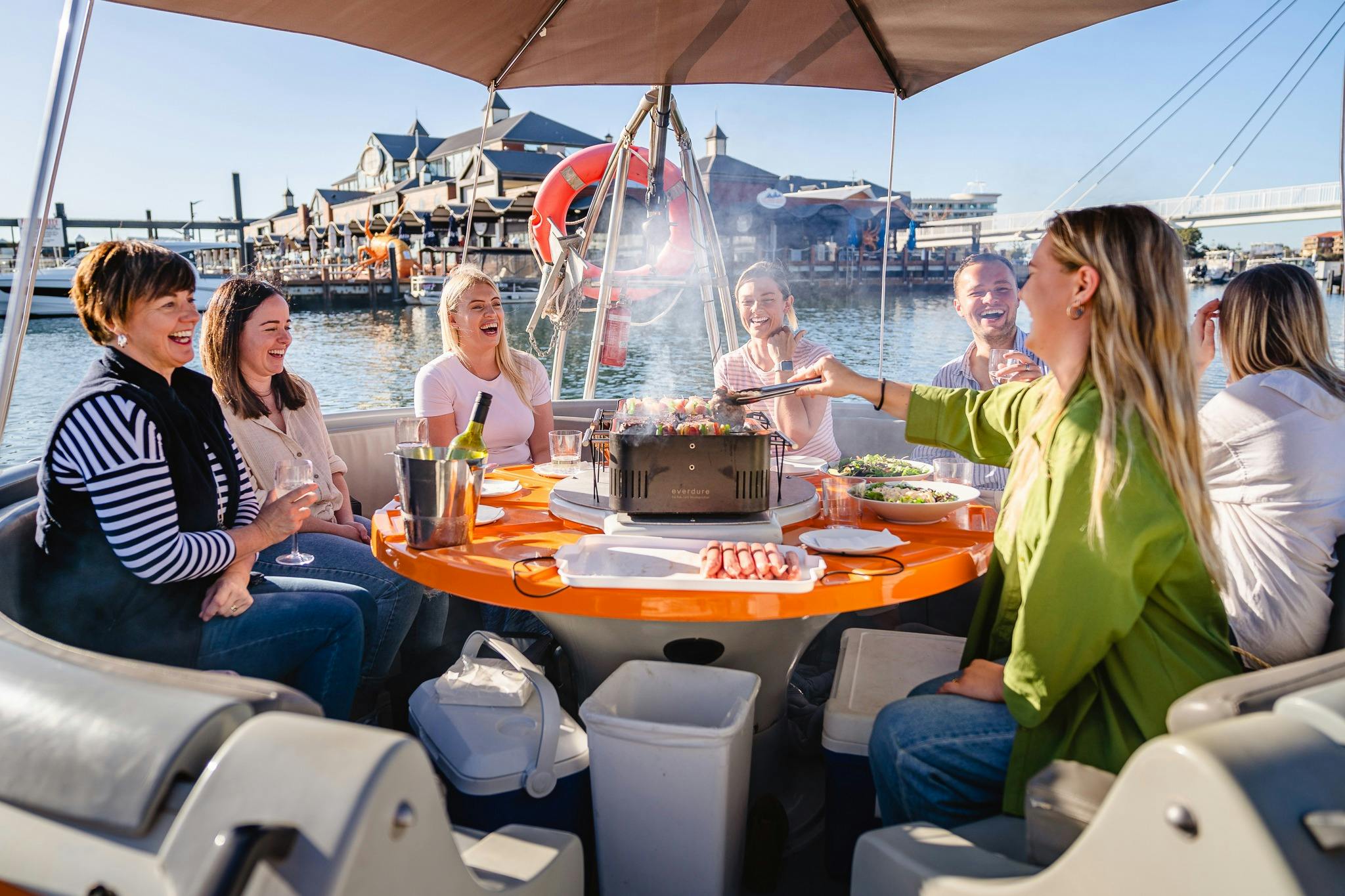 A group enjoying a BBQ on an eco BBQ boat