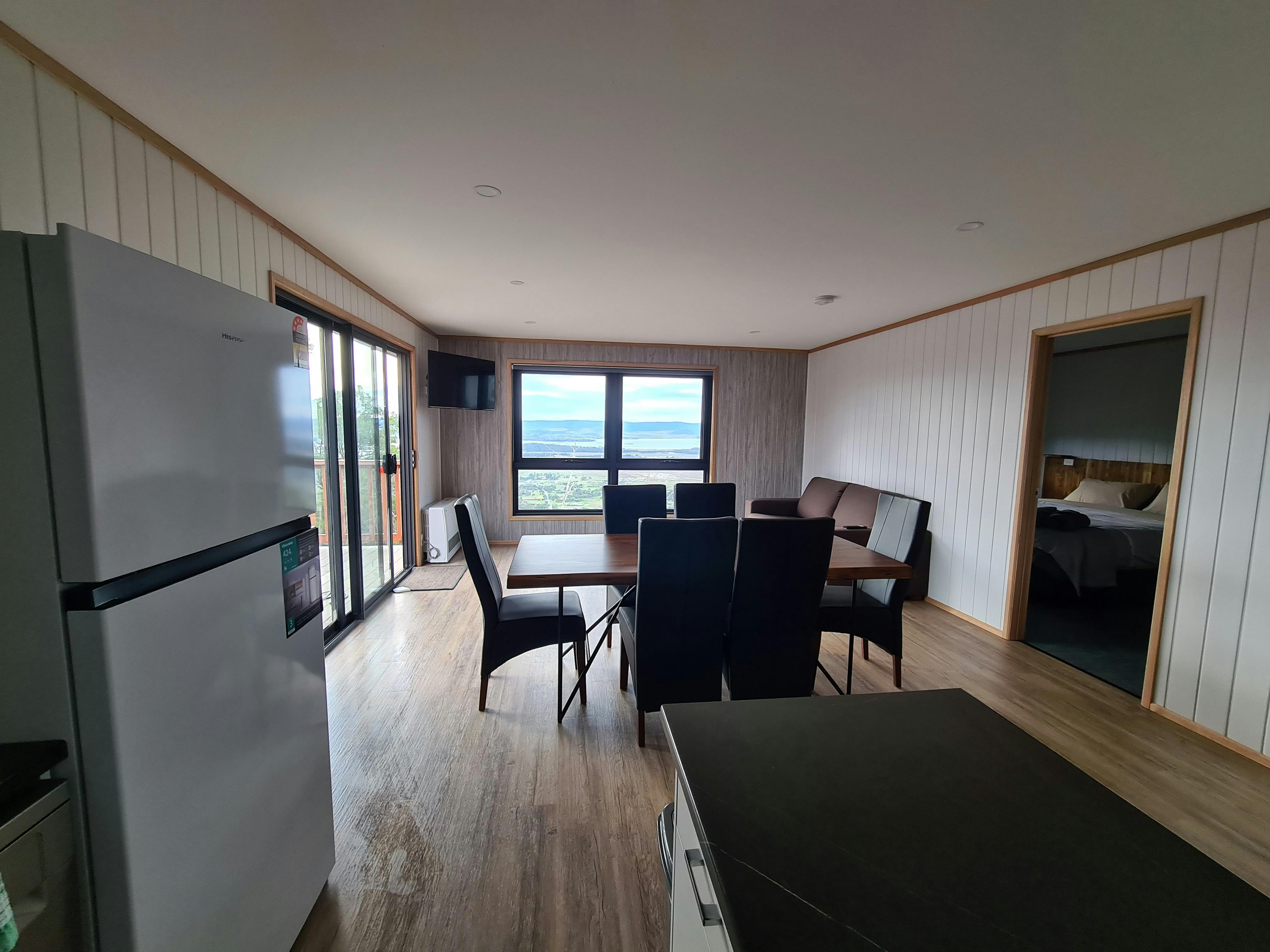 Open kitchen and dining area with appliances and timber finishes