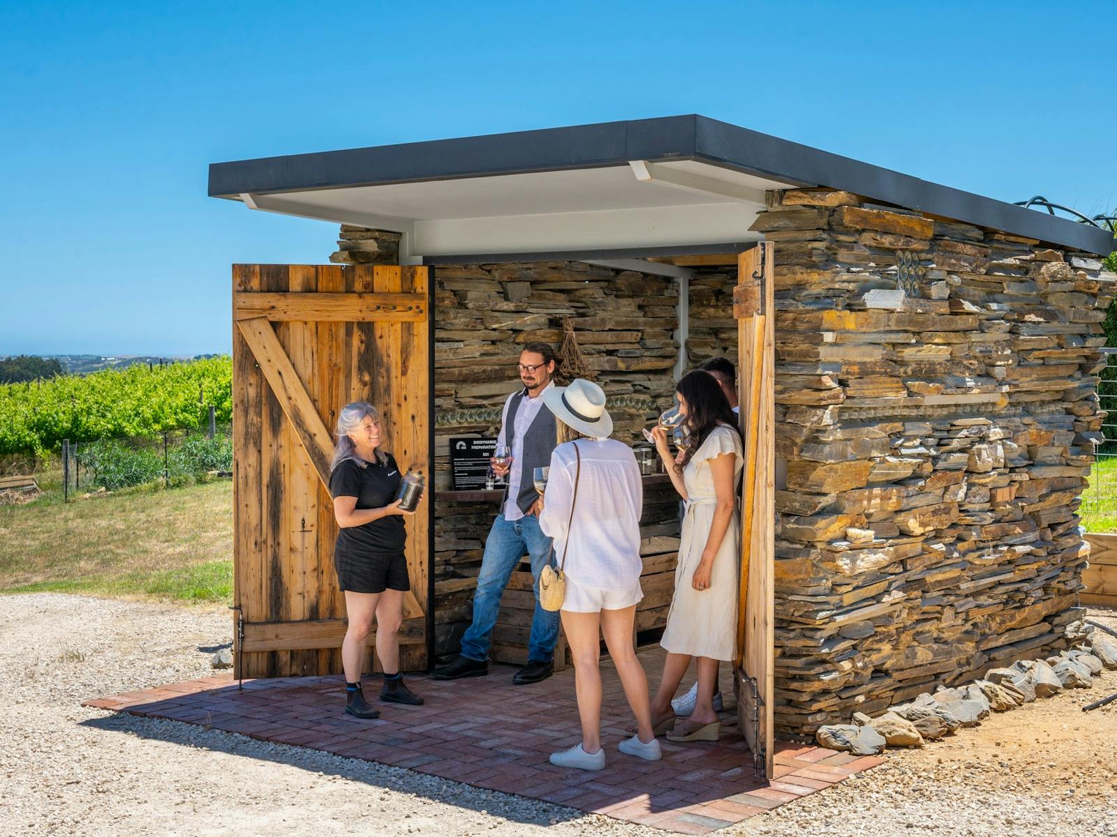 guests enjoy a wine at the Biodynamic Hut