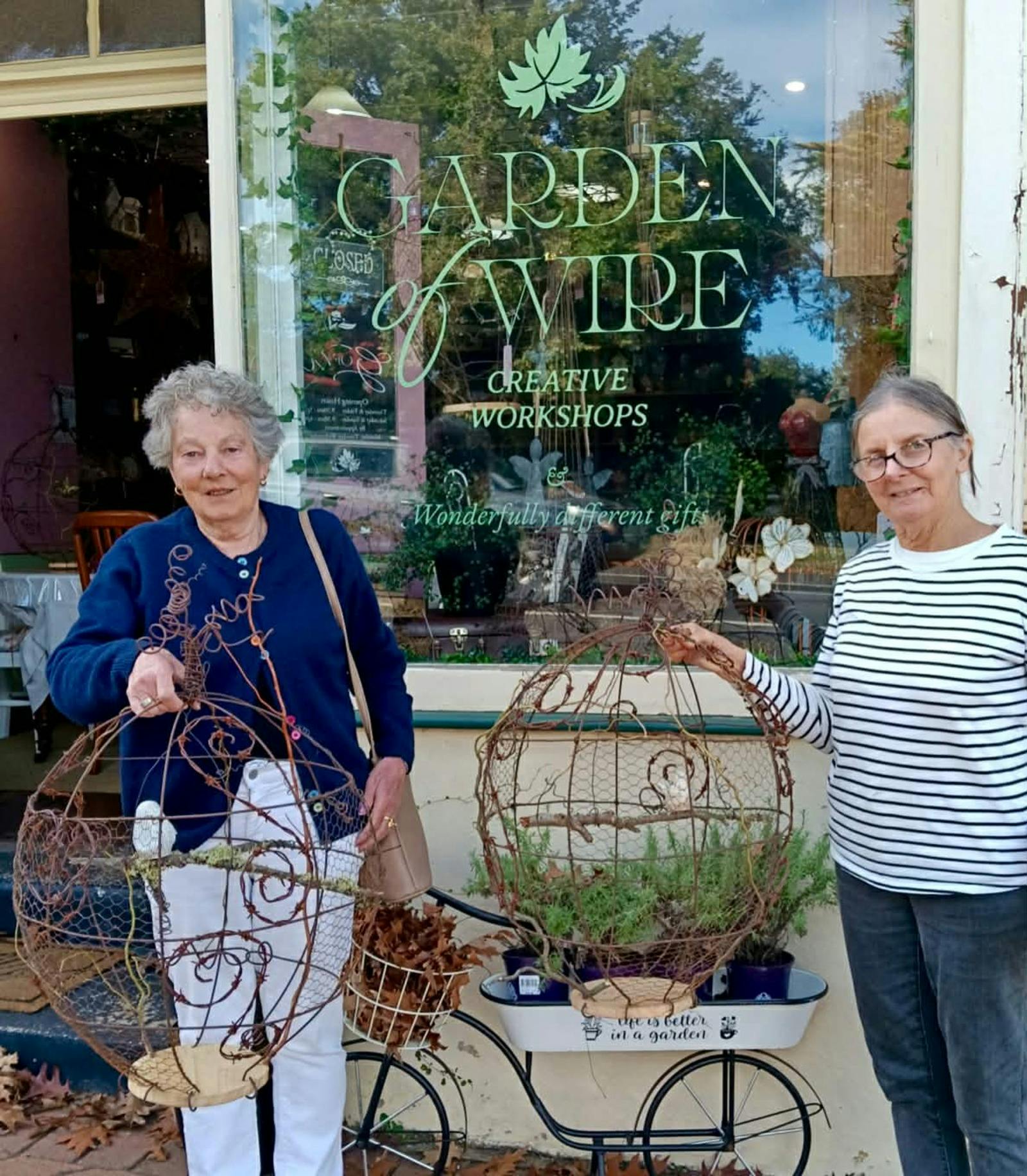 Clients standing in front of shop with Embellished Birdcages