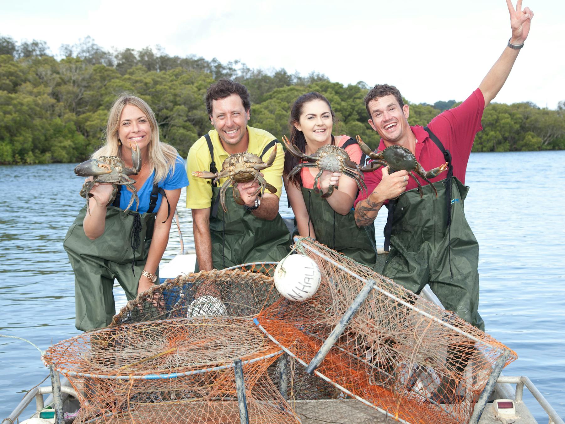 Picture of guests smiling holding caught mudcrabs.