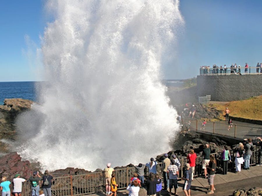 Visitors gathered around the Kiama Blowhole as water spouts up into the air