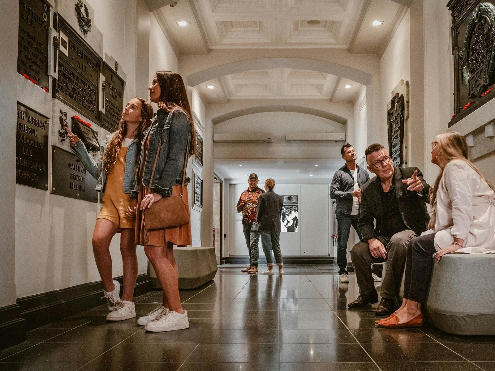 Guests on a tour exploring the World War I Memorial Crypt inside Anzac Square Memorial Galleries
