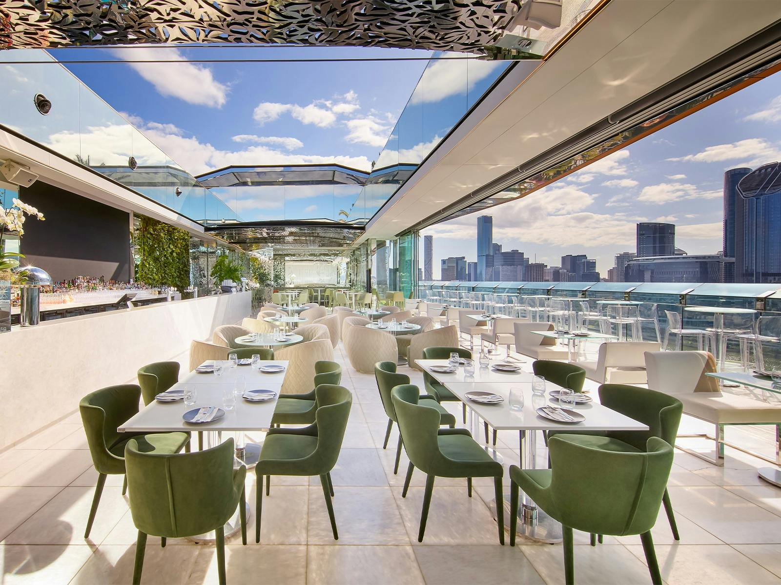 Rooftop bar with open roof and various furniture Rooftop bar with open roof and various furniture