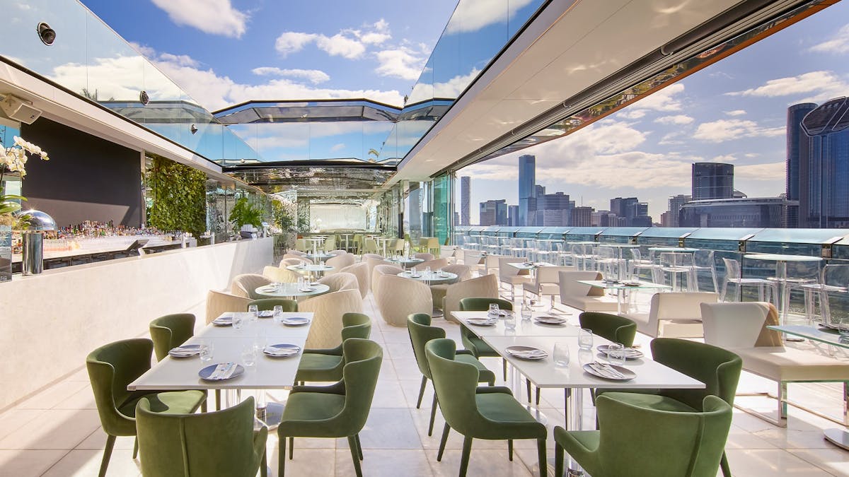 Rooftop bar with open roof and various furniture