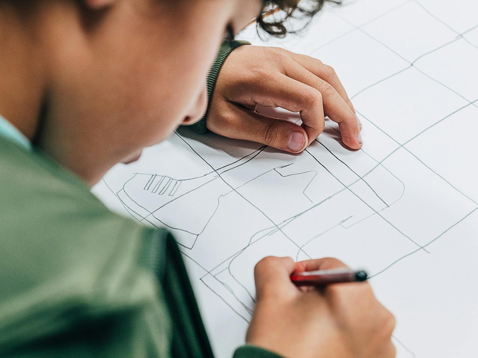 School aged boy drawing