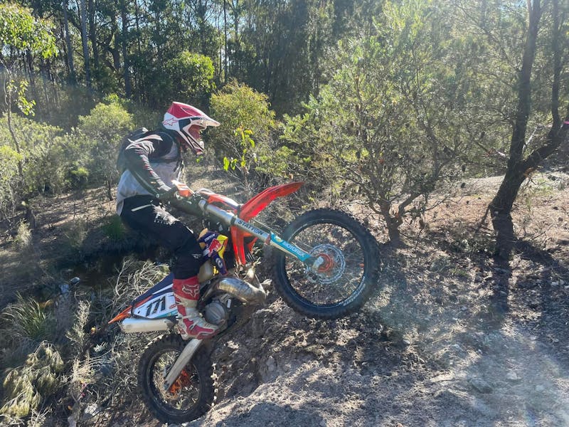 Hard Enduro Tasmania competitor on motorbike on a bush track