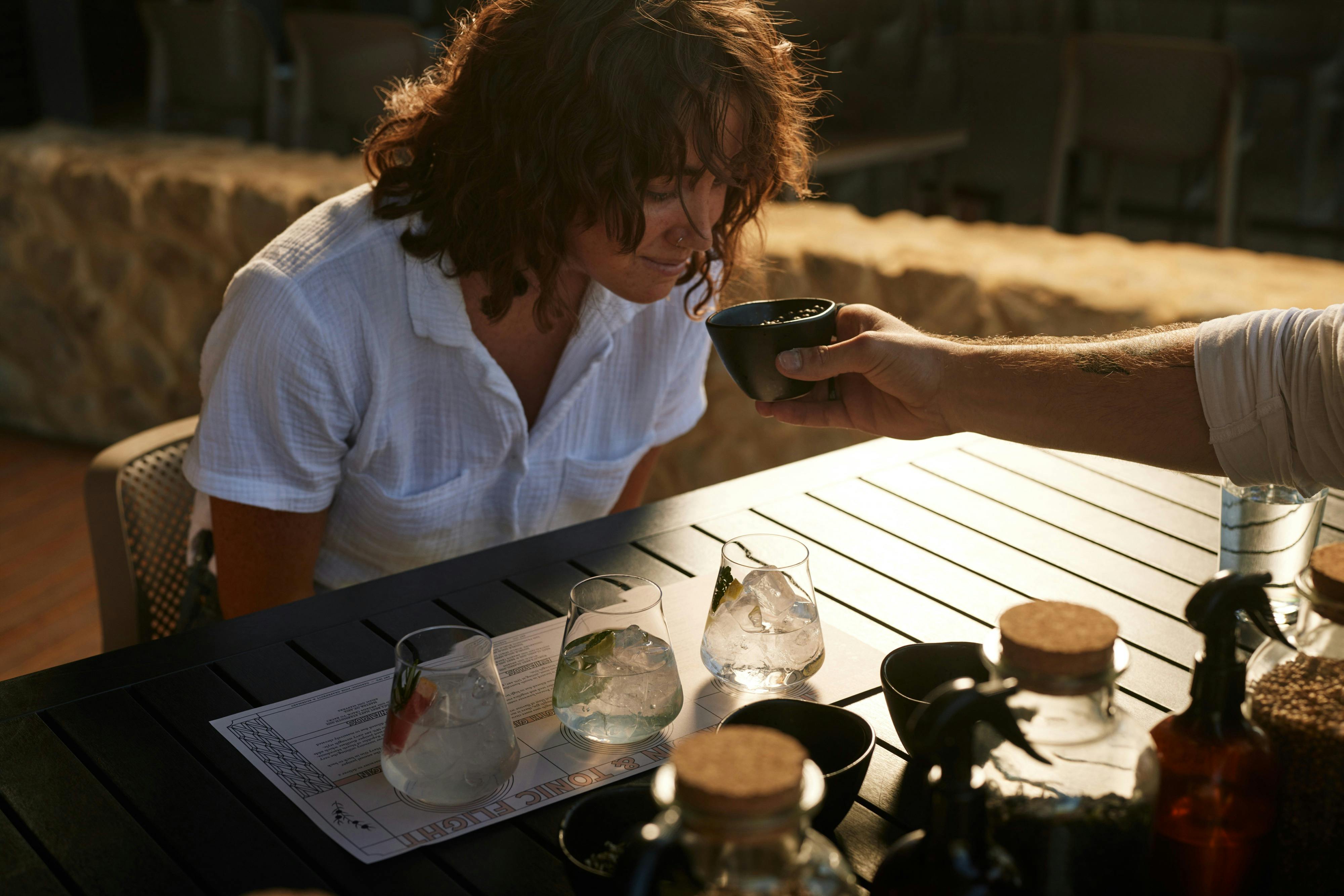 Lady sampling gin elements on a tour