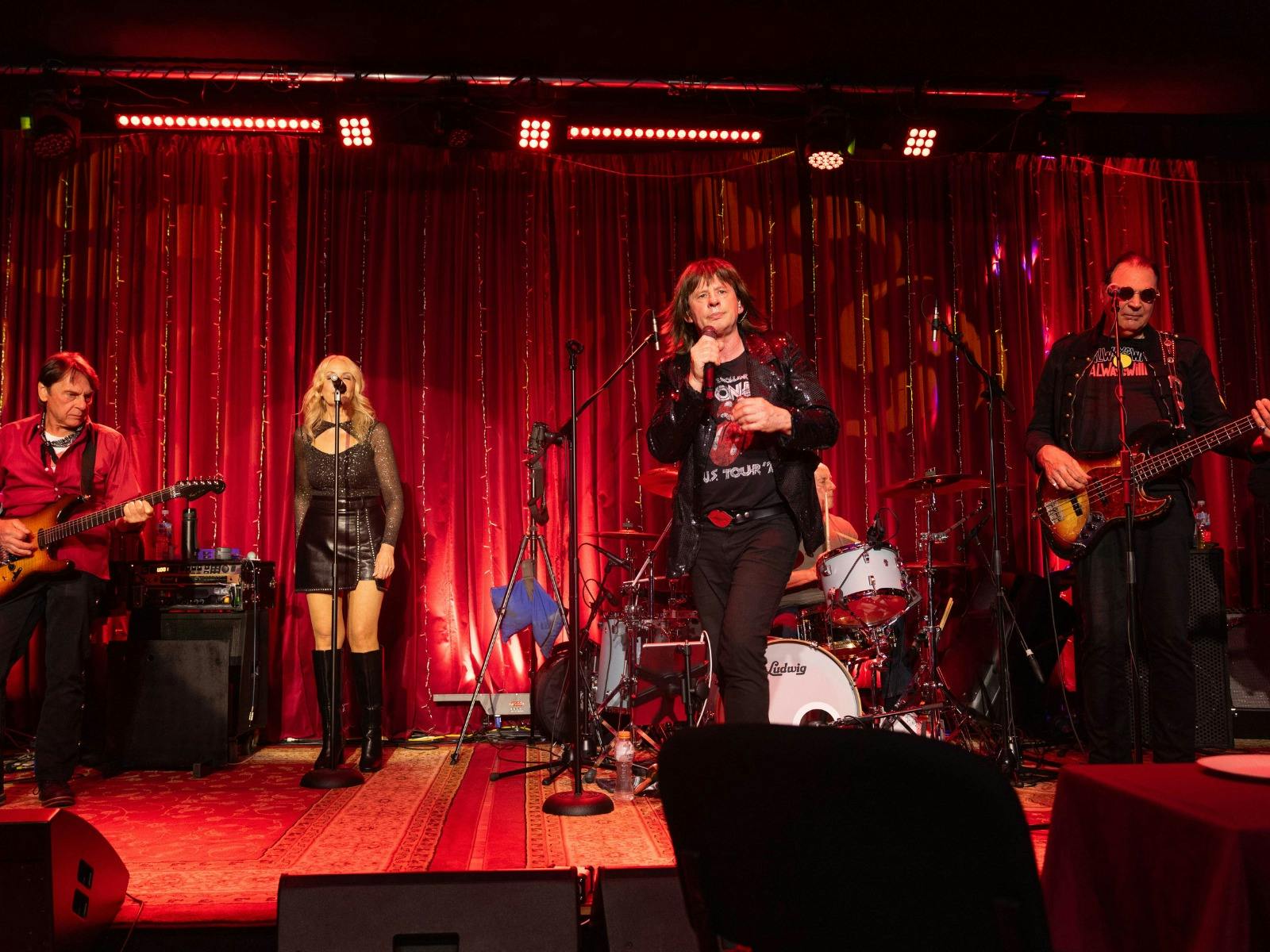 Four people on stage performing