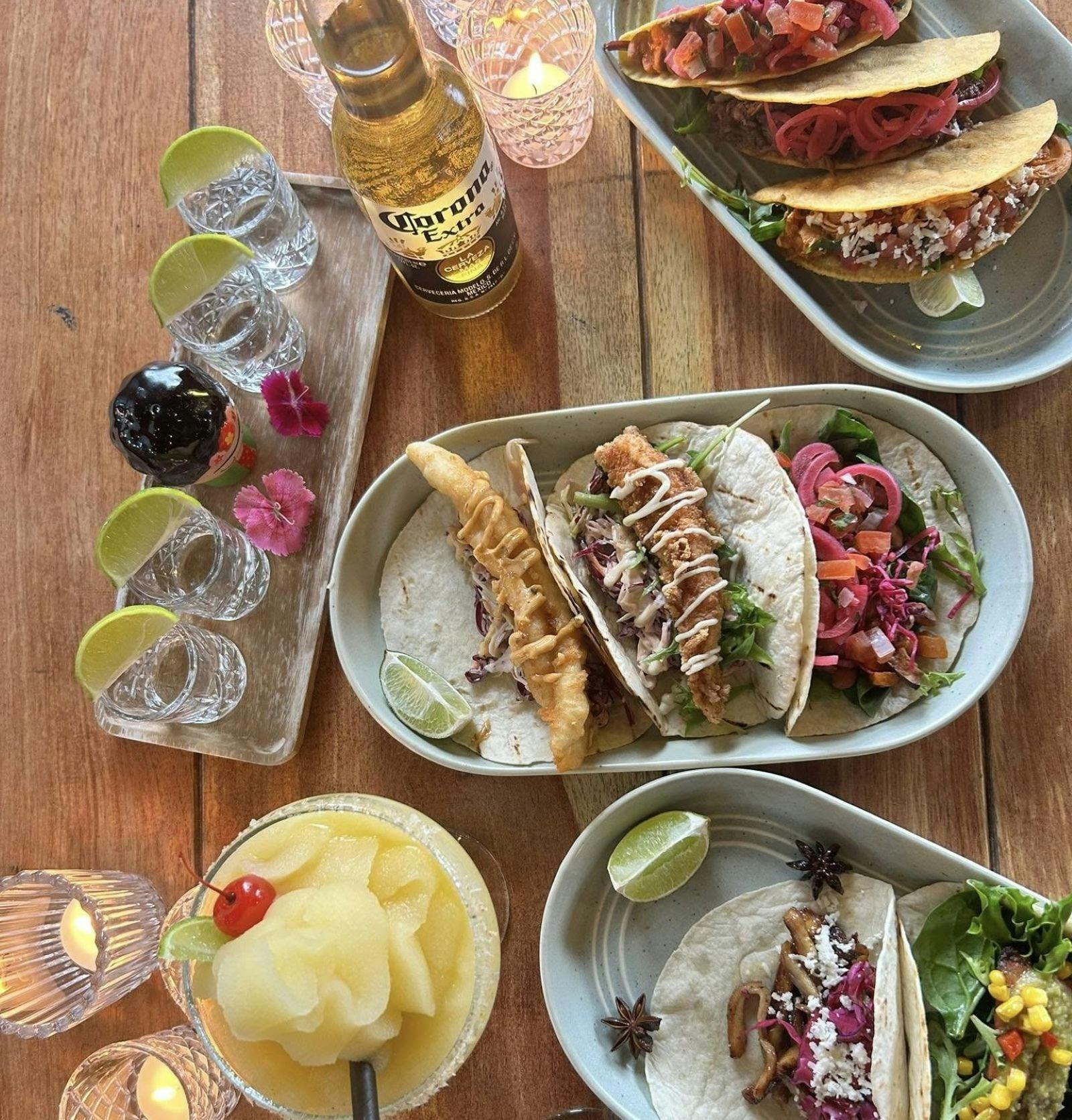 Tacos trio mixed dishes with tequila shots and lime