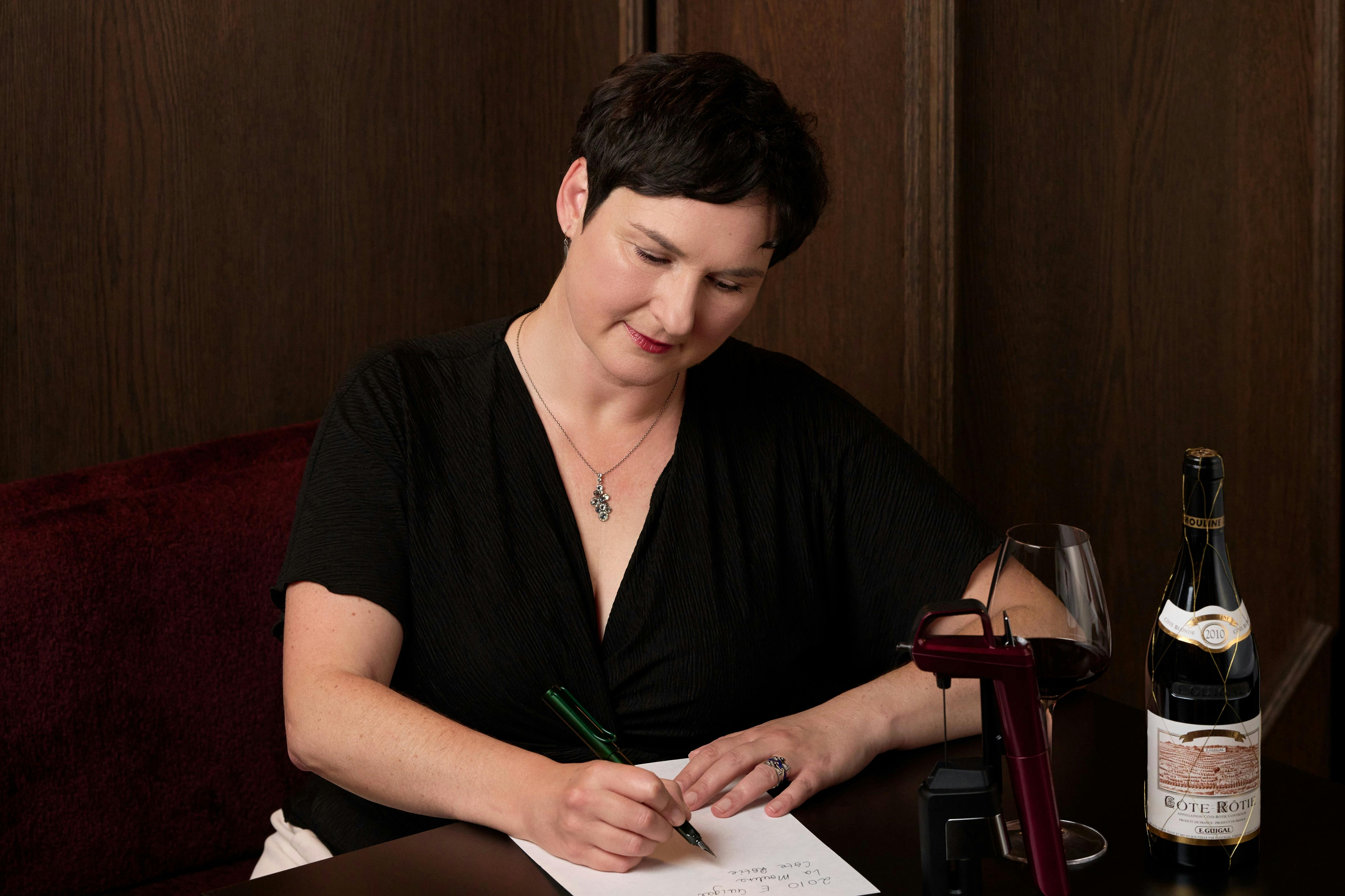 Andrea Pritzker MW tasting writing tasting notes at the Coravin Aged Wine Clinic