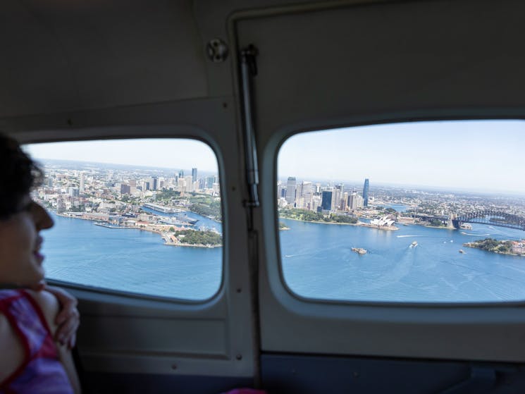 Woman enjoying a scenic Sydney Seaplanes flight from Rose Bay, Sydney
