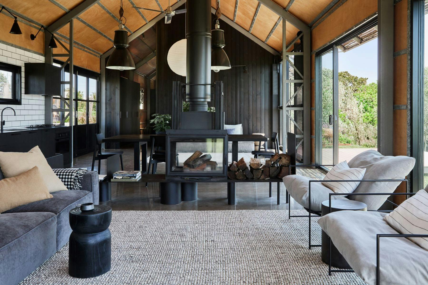 Image of interior of property. It has an industrial feel, walls and furniture are timber and black.