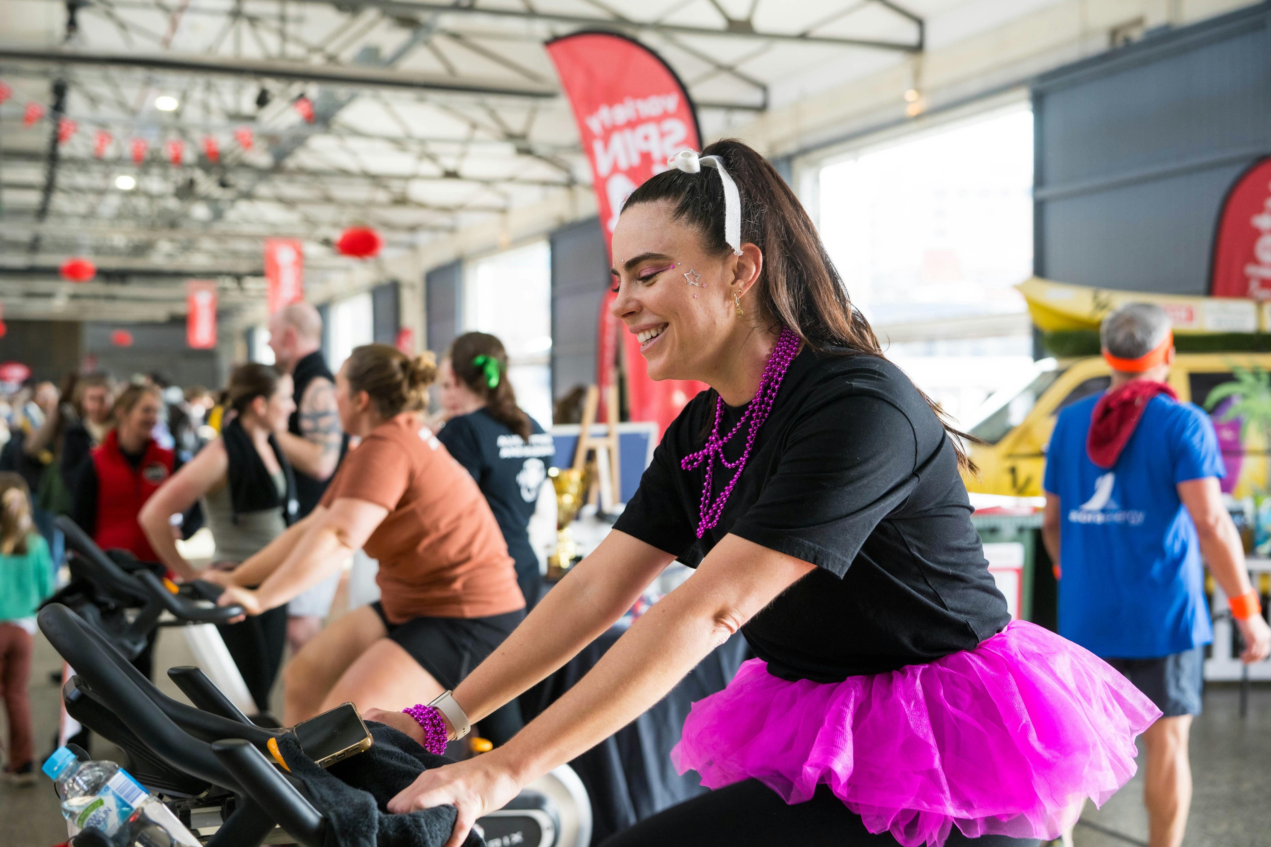 Sally in a tutu spinning to raise funds for Tassie Kids