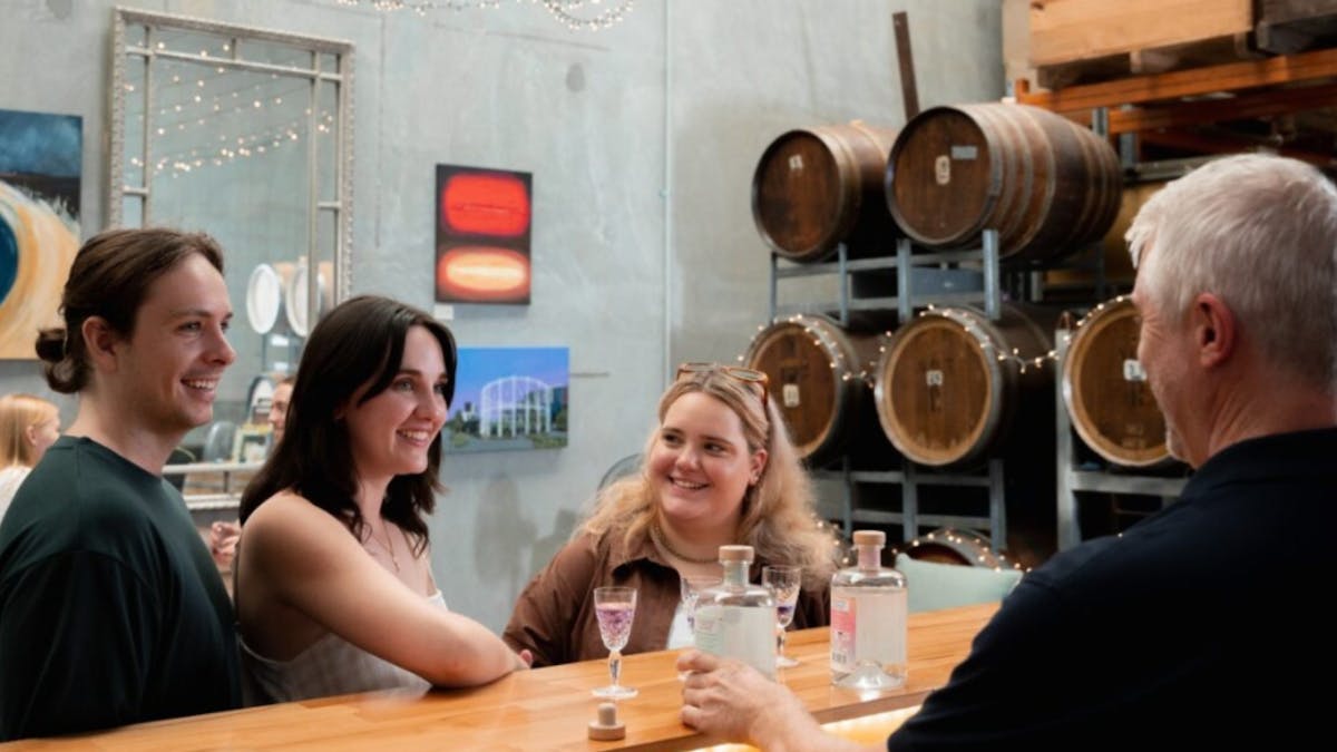 People tasting gin at the bar with the chrief distiller