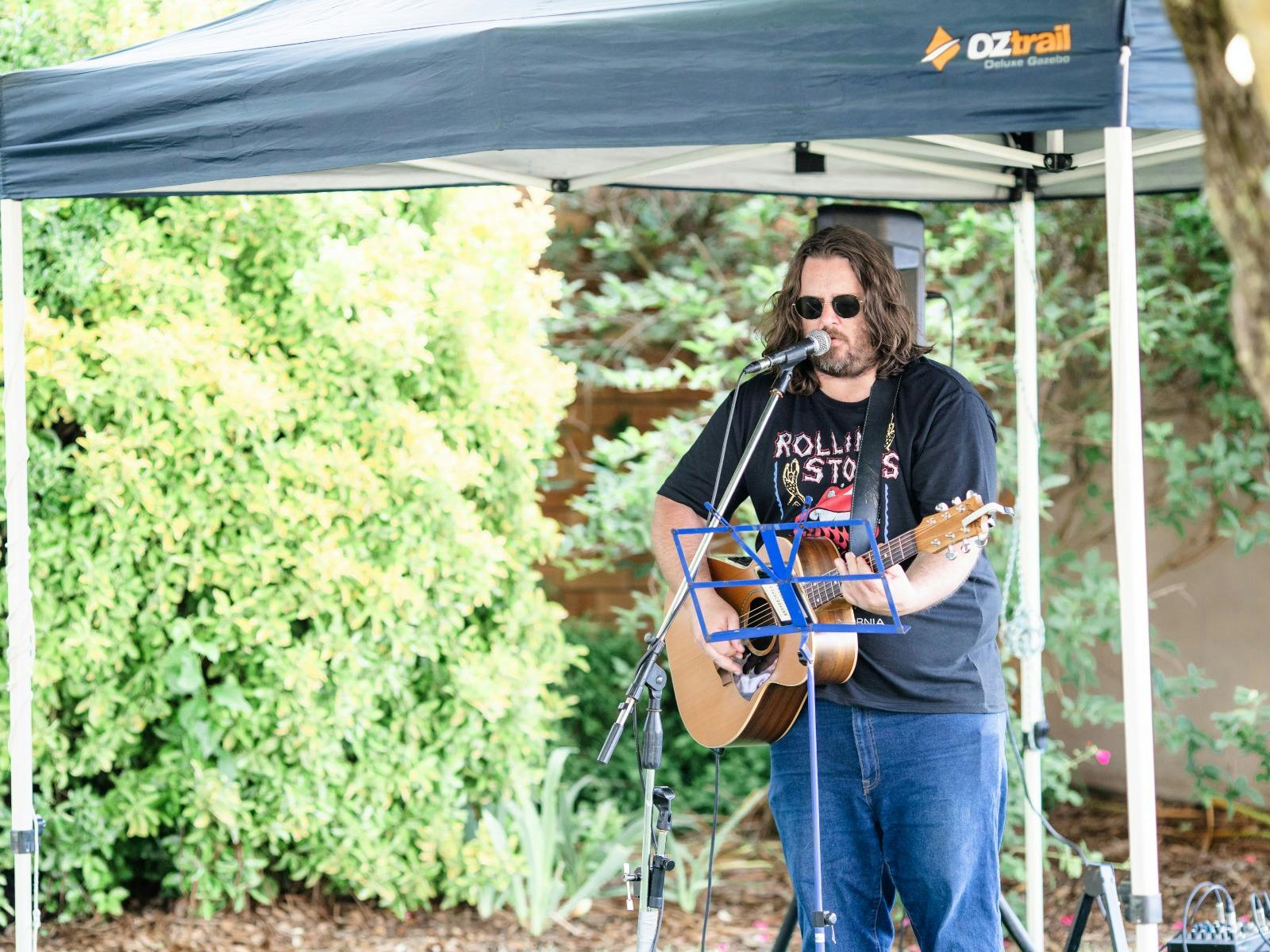 musician singing with guitar