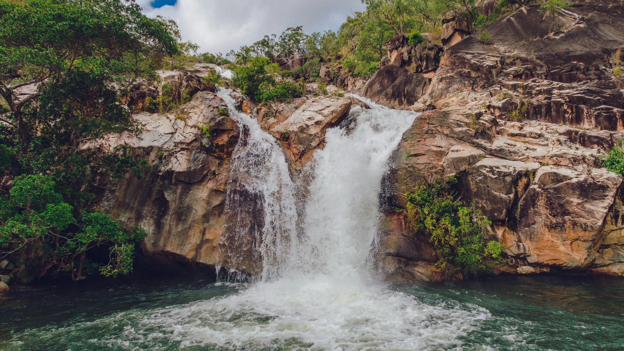 Granite bolders with crystal clear flowing waterfall in Mareeba, Tropical North Queensland. Granite bolders with crystal clear flowing waterfall in Mareeba, Tropical North Queensland.