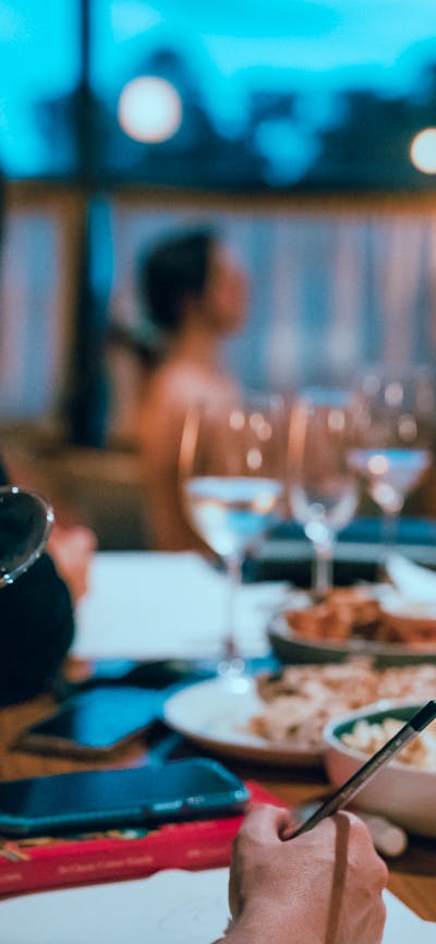 Woman drinking sparkling wine with art model sitting in background