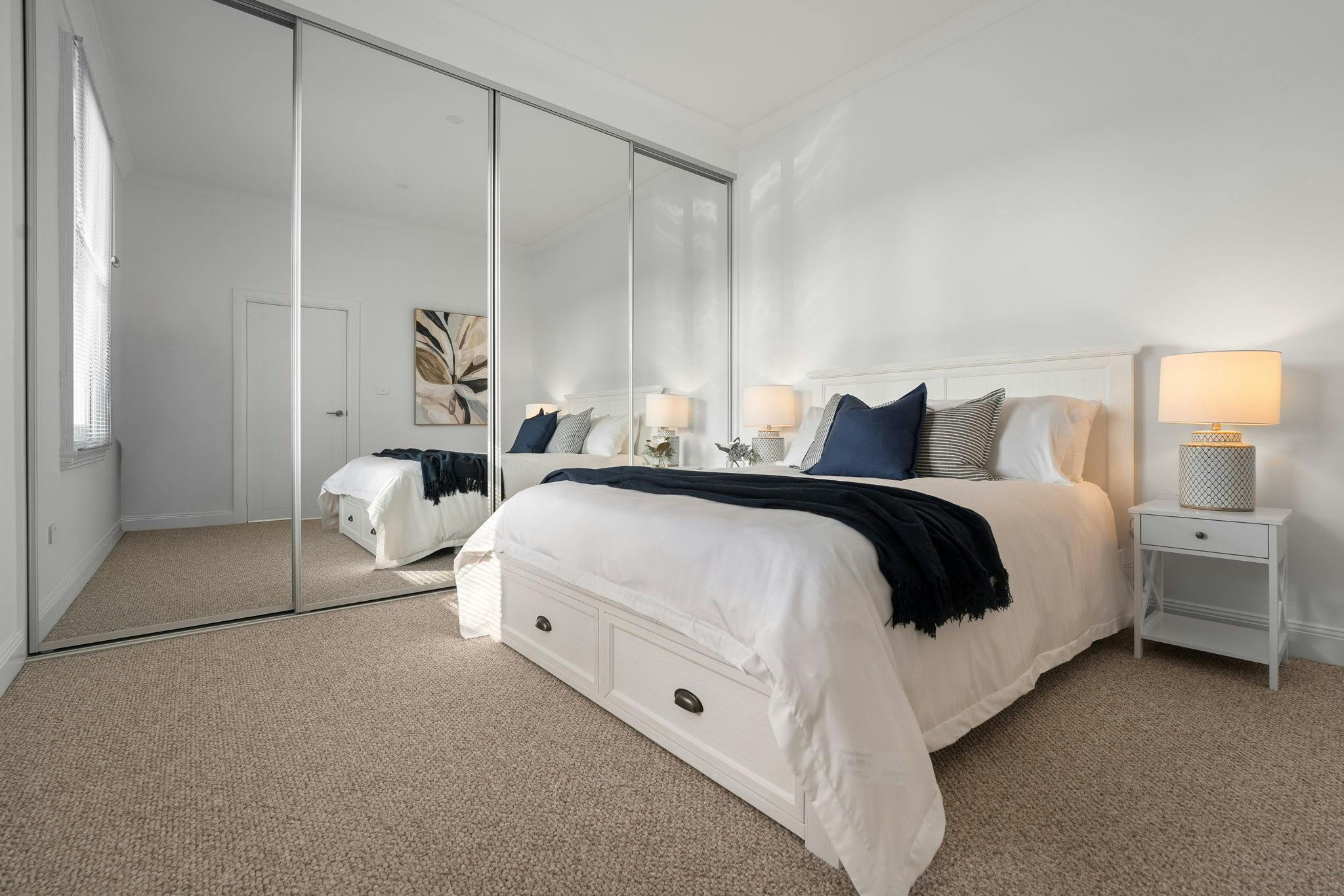 Large bedroom with queen bed, large windows for the wardrobe