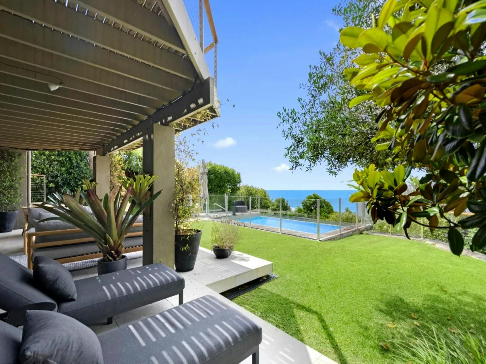 A tranquil poolside oasis with stunning vistas of the sparkling ocean